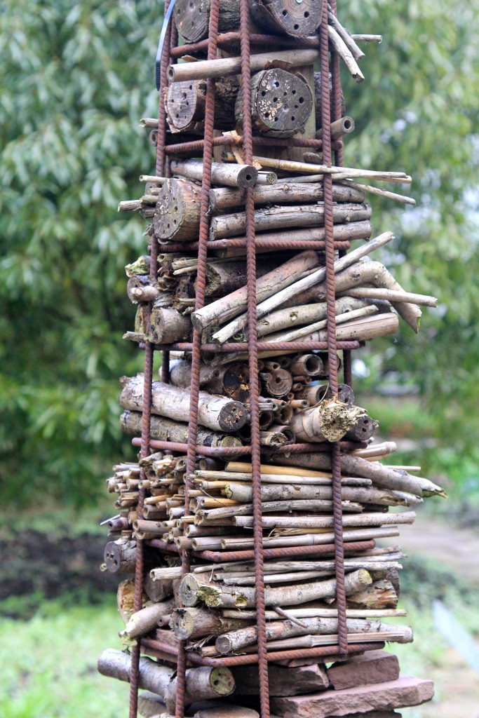 This lovely beneficial insect home build from gathered twigs, grasses and mossy bricks looks more like a piece of garden.